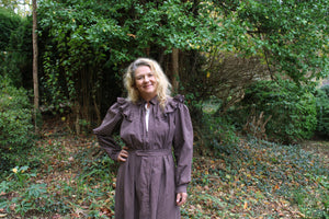 Close up off the top of the Calico Day Dress on a woman standing outside with one hand on her hip.