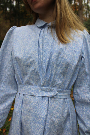 Close up of the blue calico Day Dress on a woman