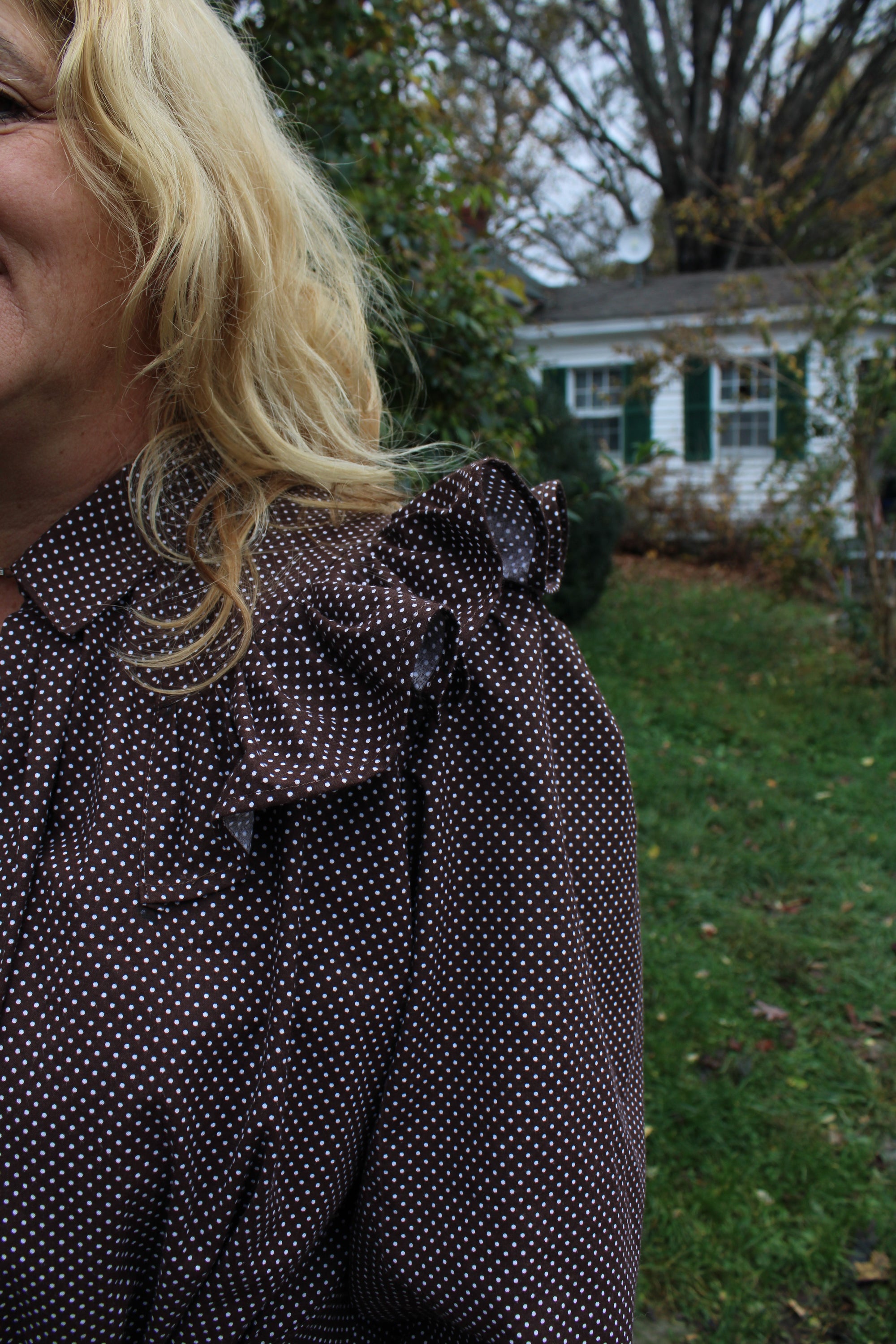 Close up of the shoulder ruffle on a brown traditional day dress