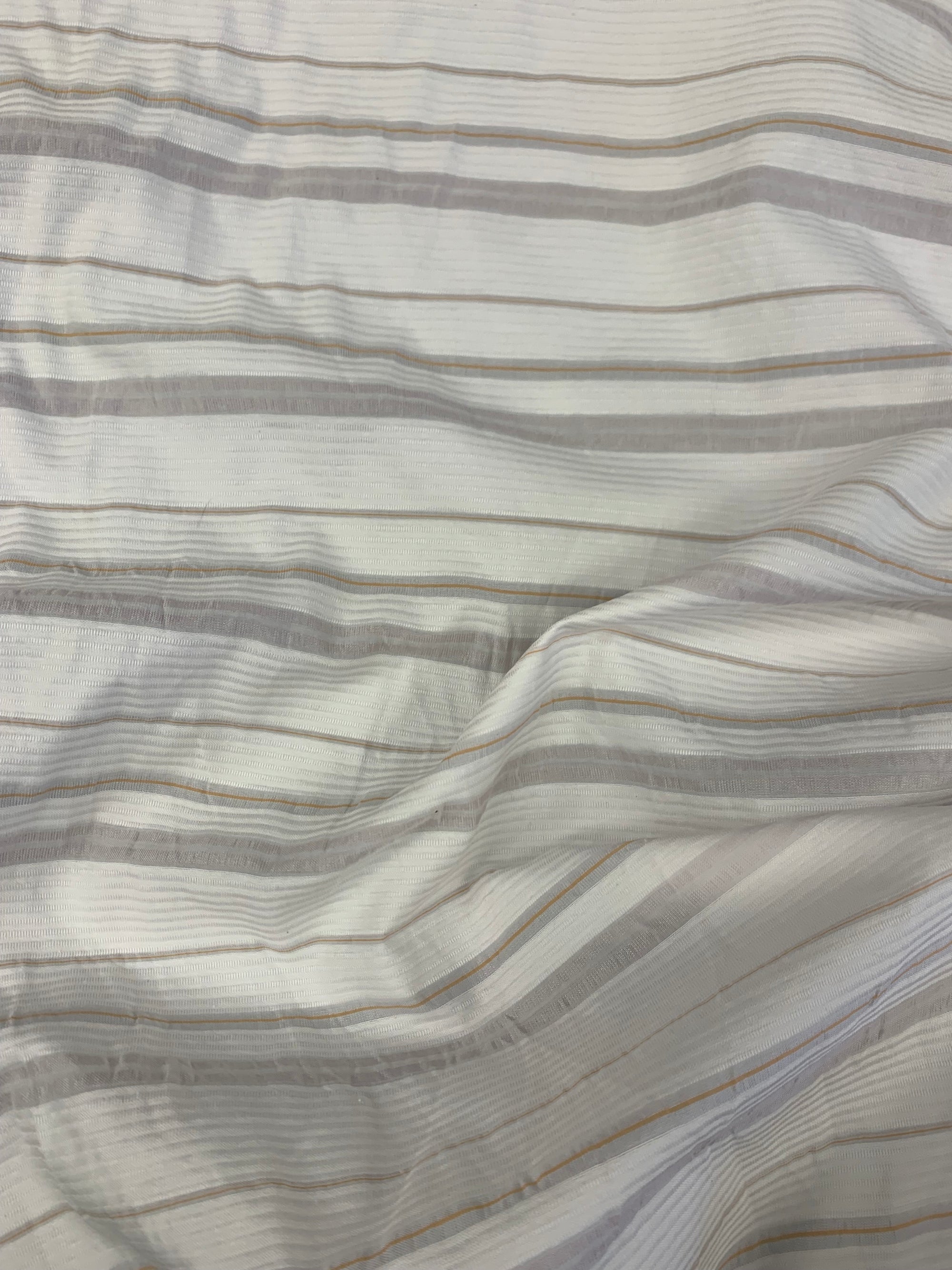 fabric is cotton poly blend with horizonal stripes of white, light pink and orange with measuring tape of the left side