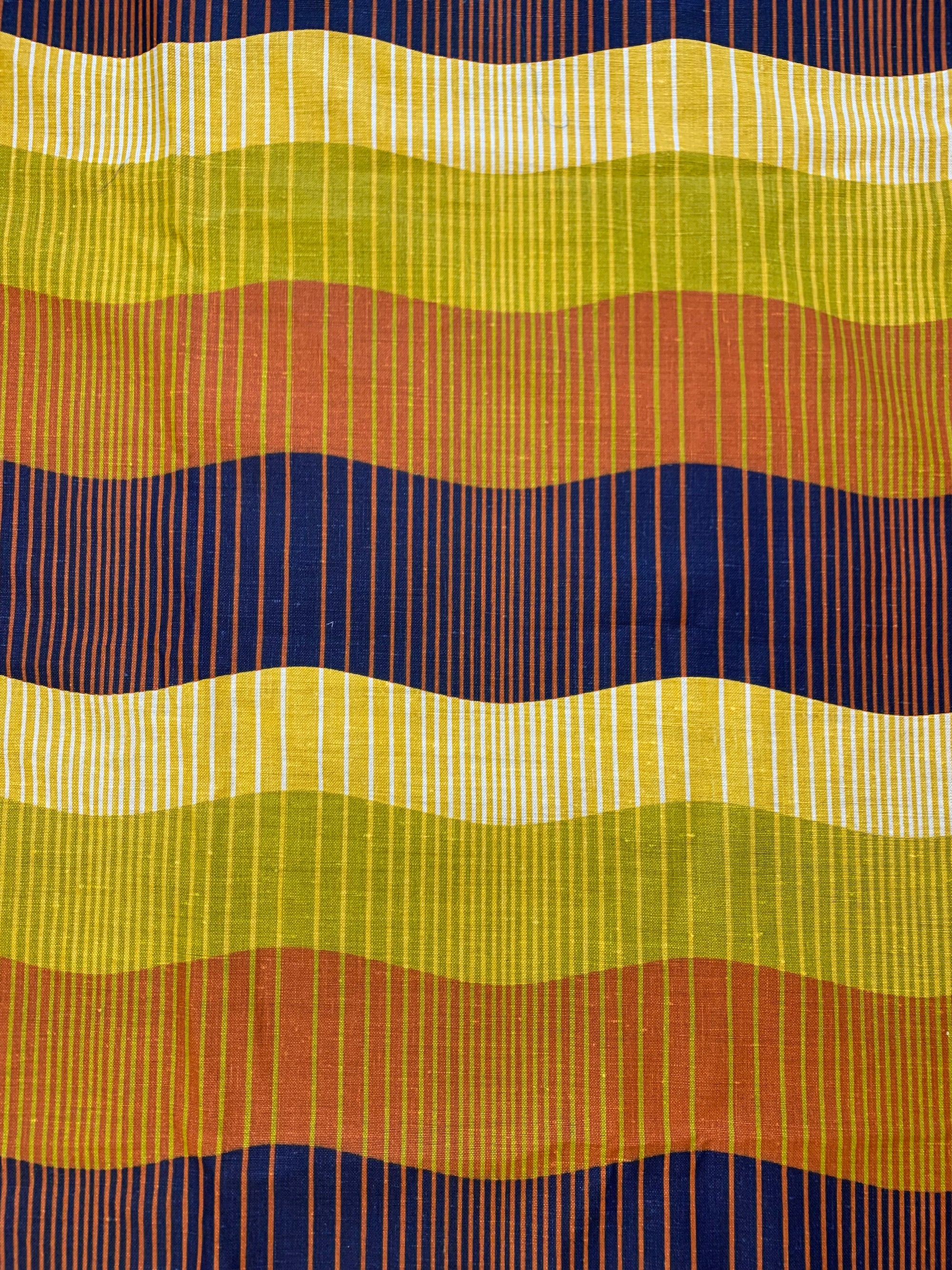 wavy horizontal stripes of chartreuse, orange and  indigo and vertical striped of white, mustard, chartreuse and orange. Linen fabric.